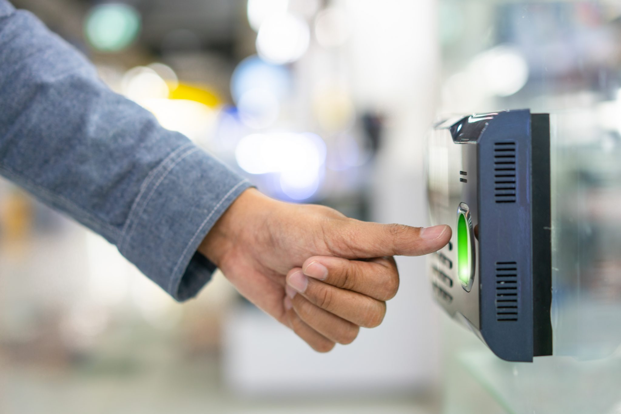 Employee scanning fingerprint record hours work time strandum hr